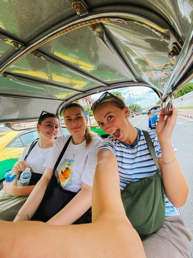 Traveler exploring urban Thailand with a backpack in a city street