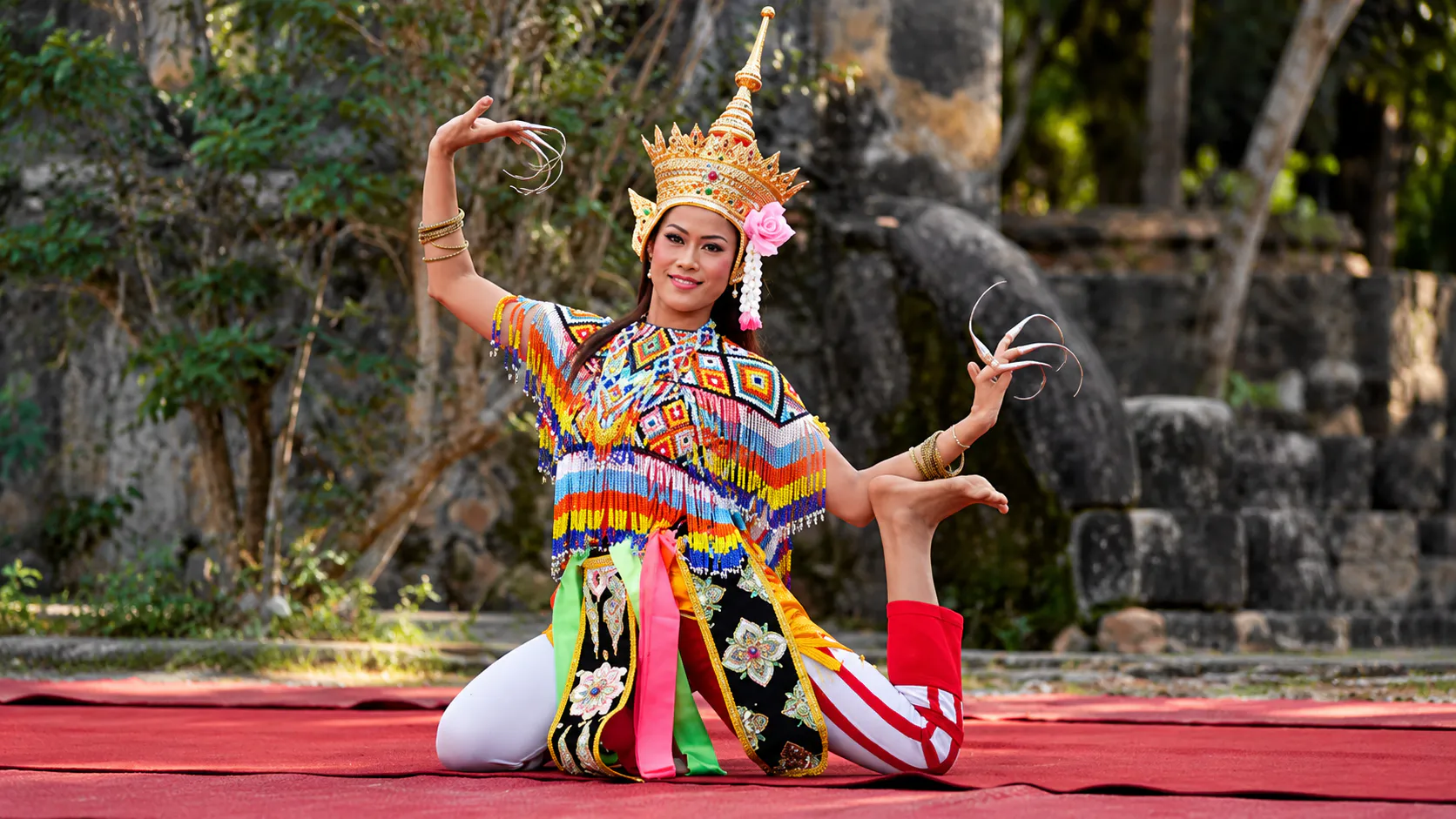 Nora dancer in elaborate southern Thai costume performing outdoors